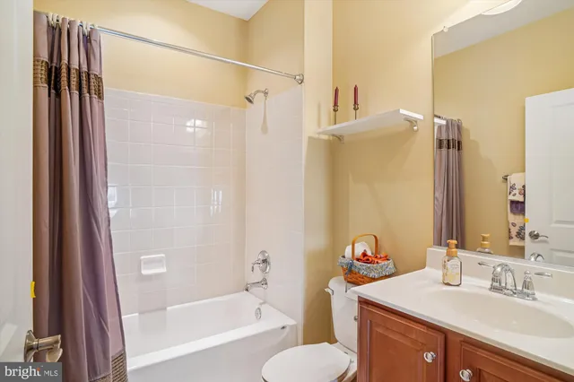 a bathroom with a sink toilet tub and shower