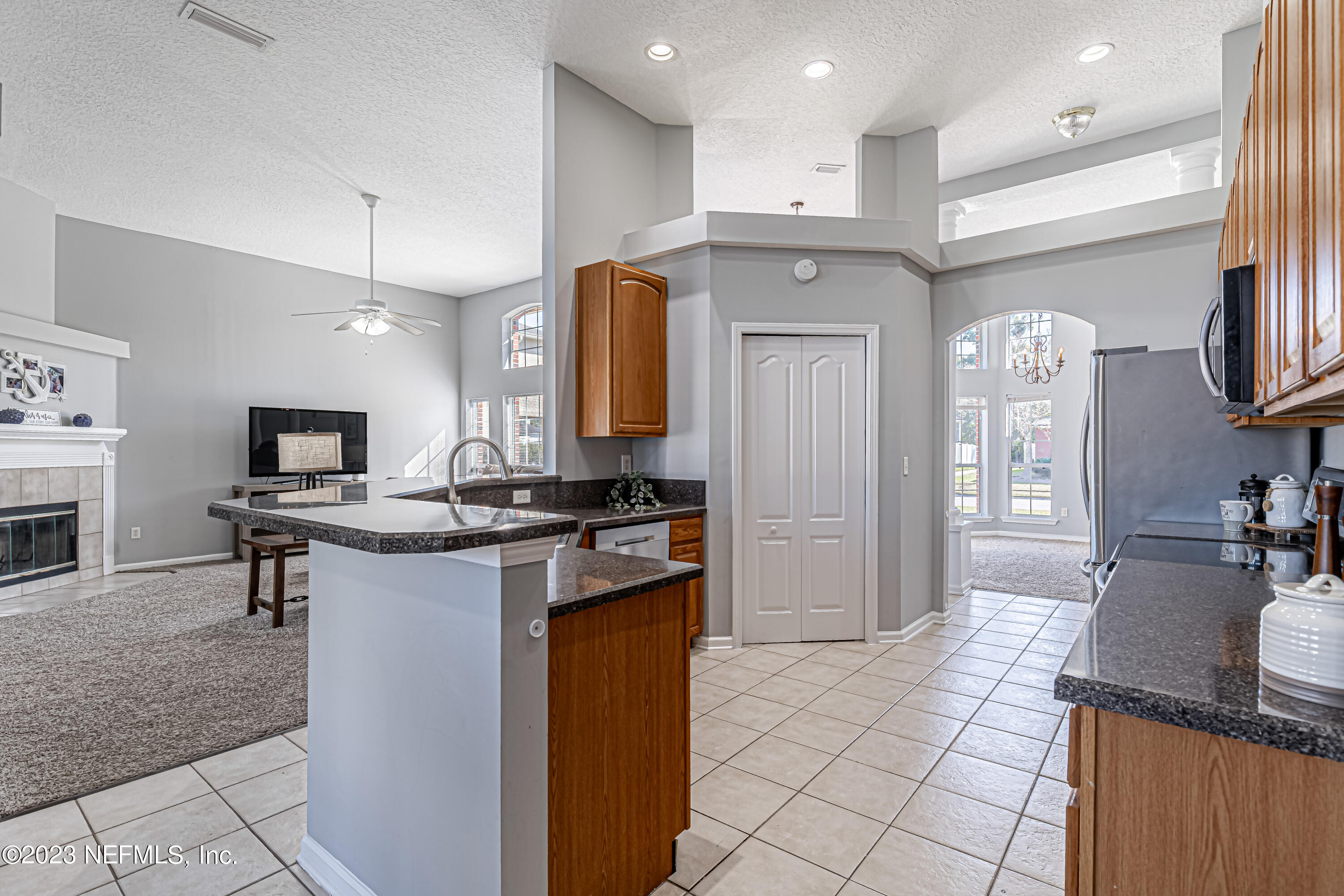 3795 Bedford Drive Middleburg, FL 32068 - Photo 18 of 54 a kitchen with stainless steel appliances granite countertop a sink and a refrigerator