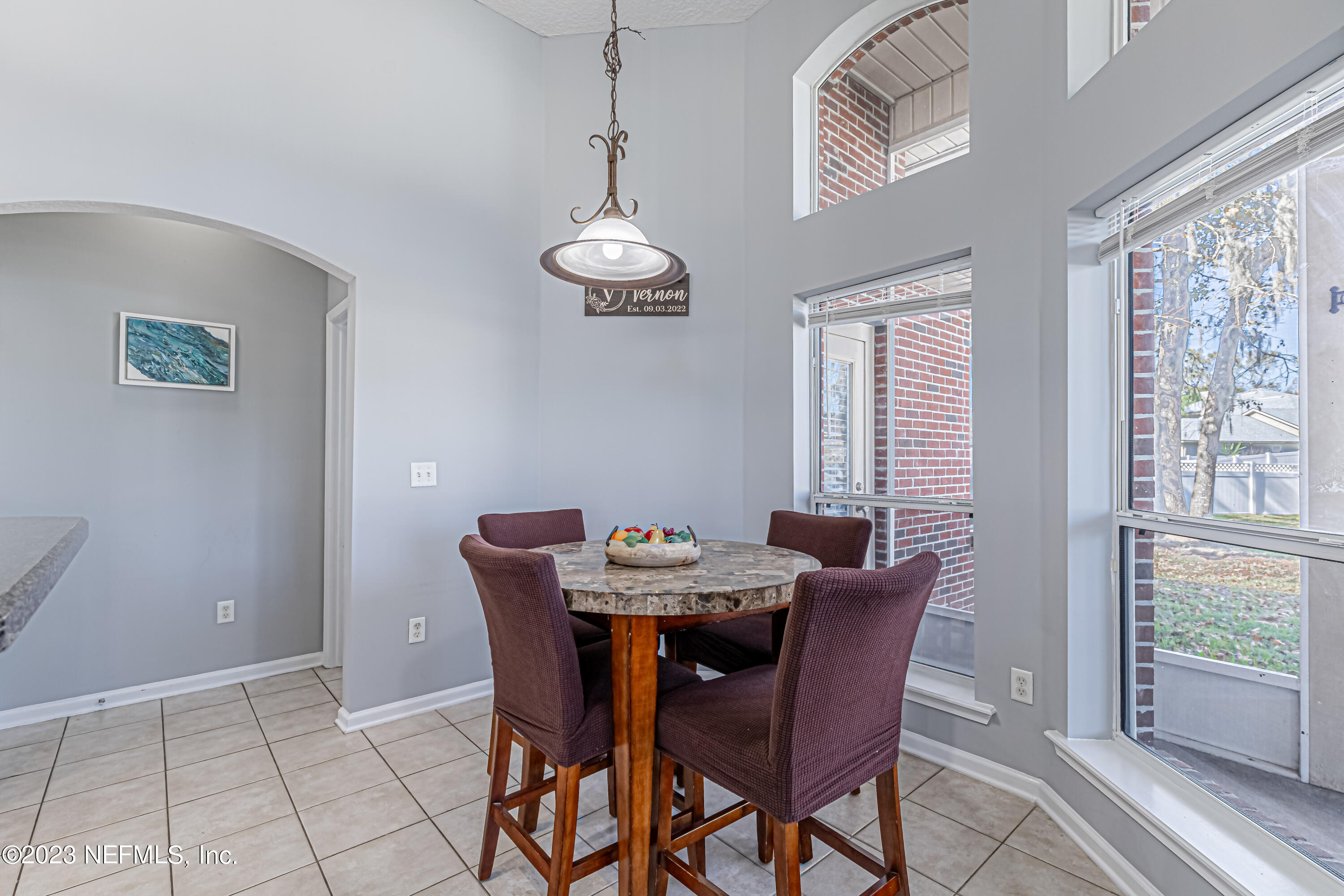 3795 Bedford Drive Middleburg, FL 32068 - Photo 19 of 54 a view of a dining room with furniture wooden floor and a chandelier