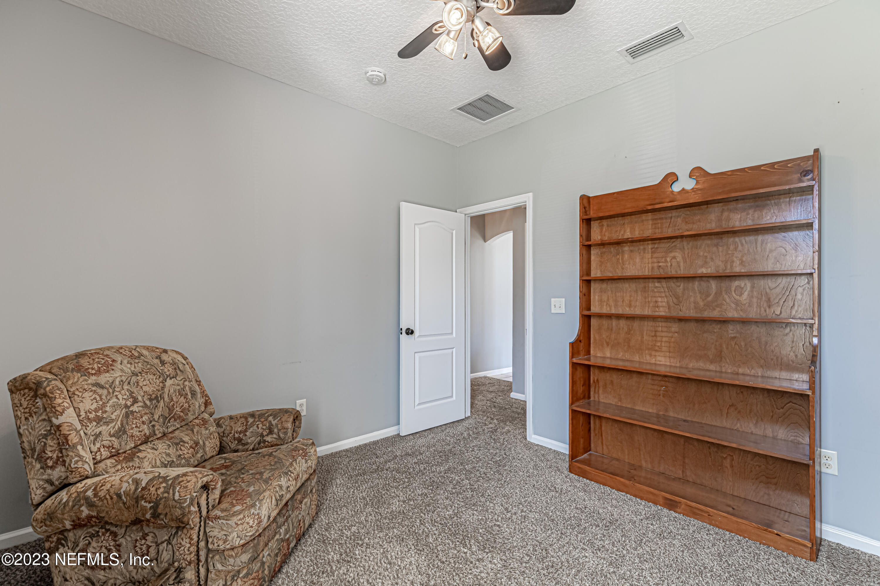 3795 Bedford Drive Middleburg, FL 32068 - Photo 23 of 54 a living room with furniture and a dresser