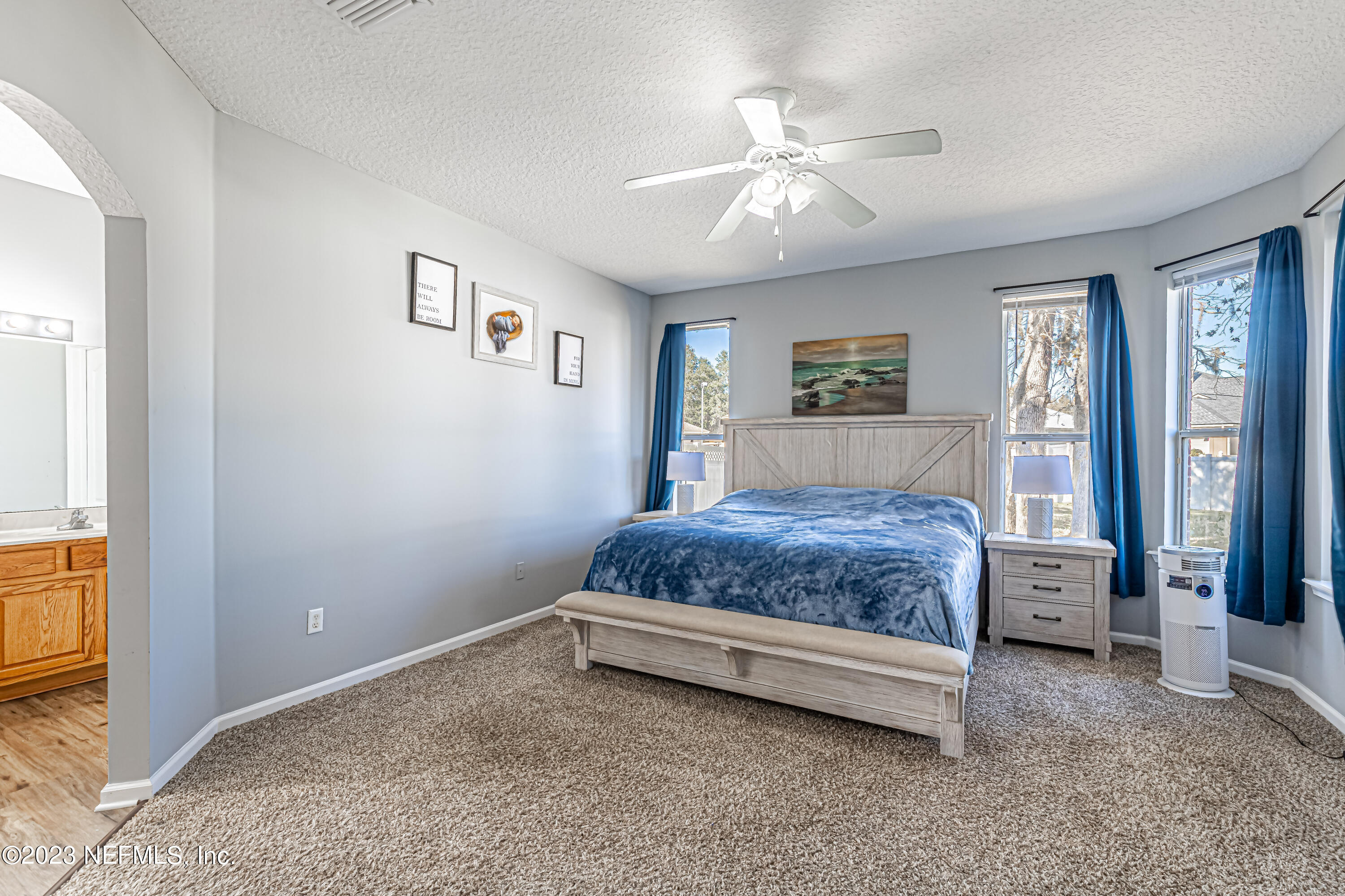 3795 Bedford Drive Middleburg, FL 32068 - Photo 27 of 54 a bedroom with a large bed and a chandelier