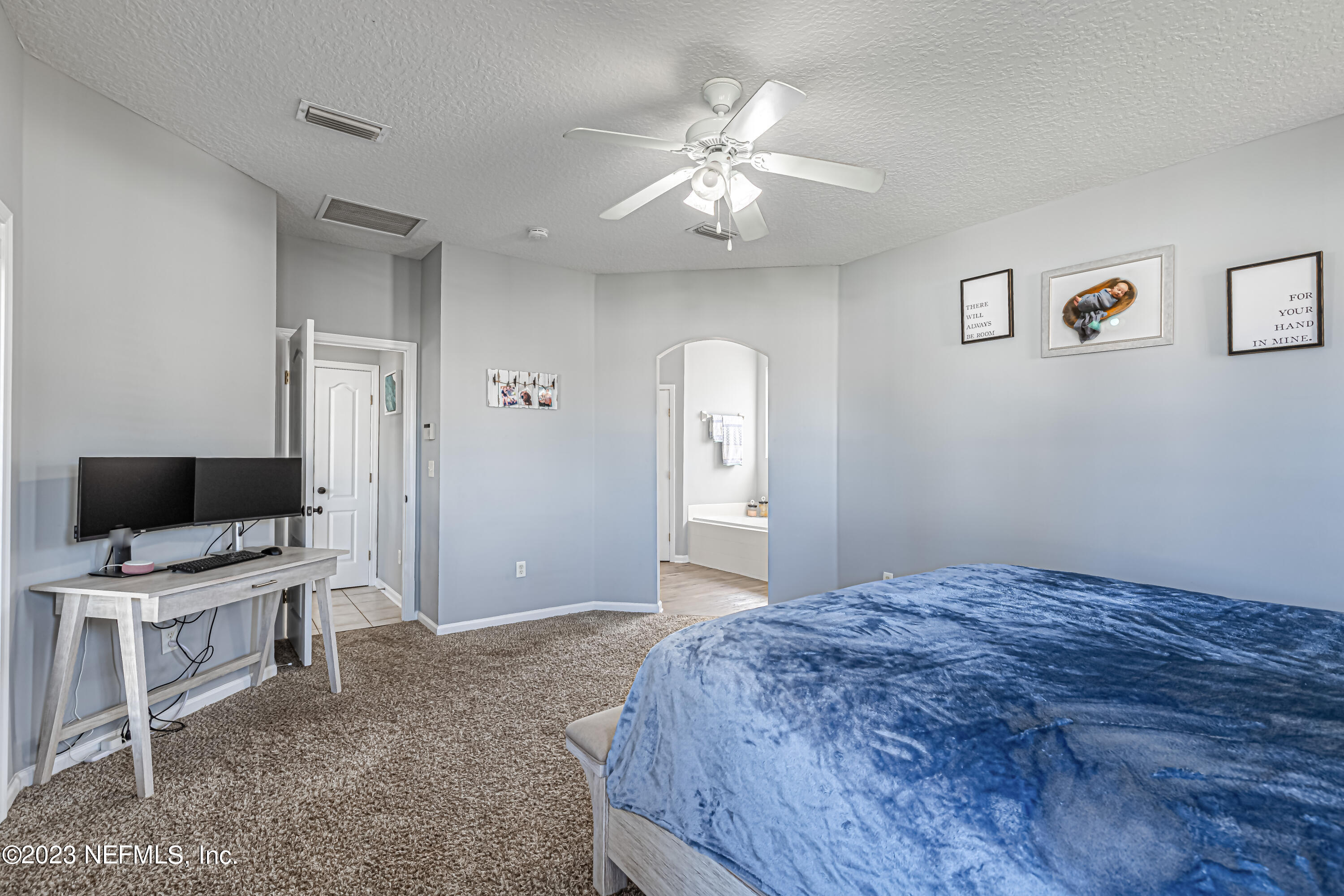 3795 Bedford Drive Middleburg, FL 32068 - Photo 28 of 54 a bedroom with a bed and a flat screen tv