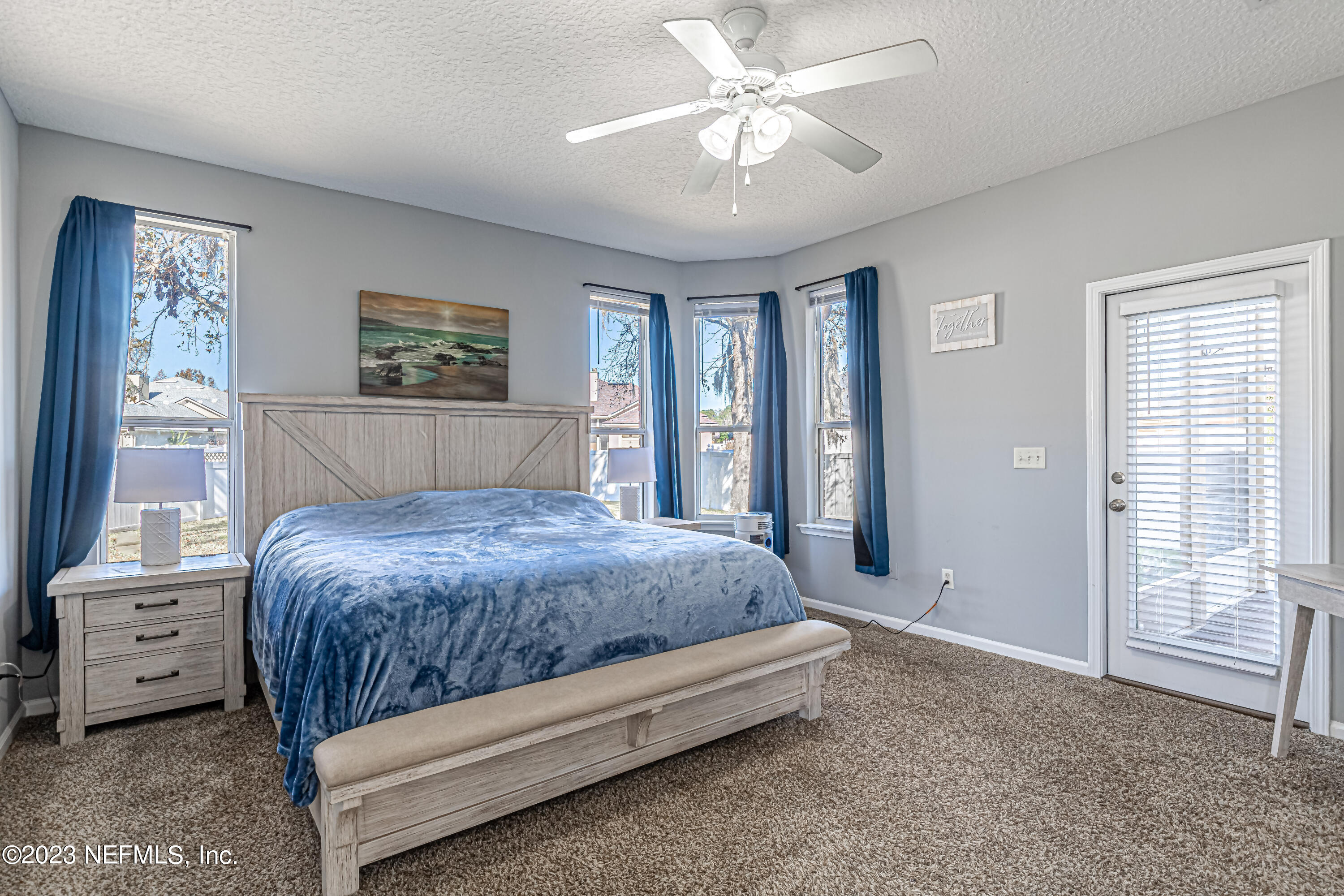 3795 Bedford Drive Middleburg, FL 32068 - Photo 29 of 54 a bedroom with a large bed and a chandelier