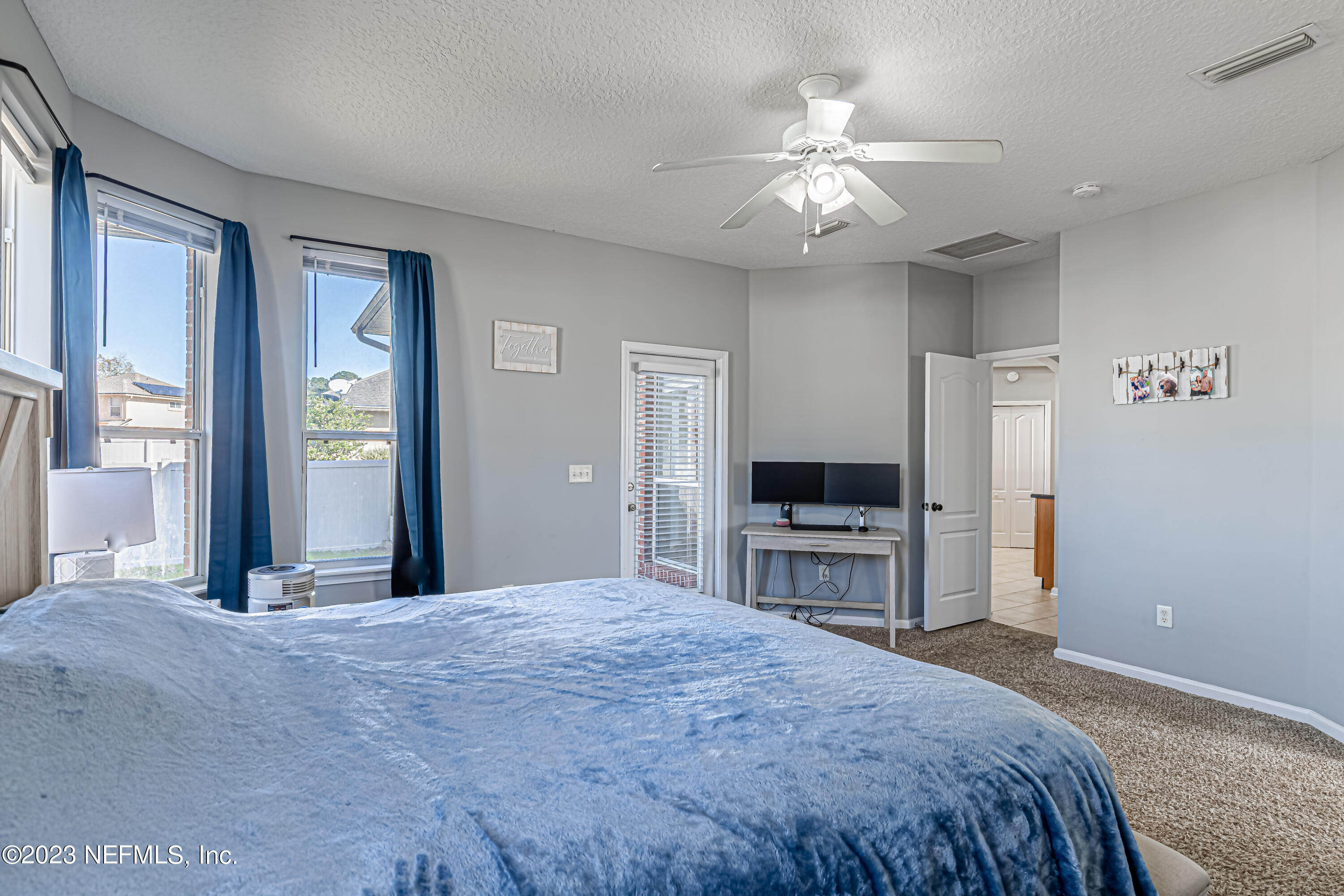 3795 Bedford Drive Middleburg, FL 32068 - Photo 30 of 54 a bedroom with a large bed and a chandelier