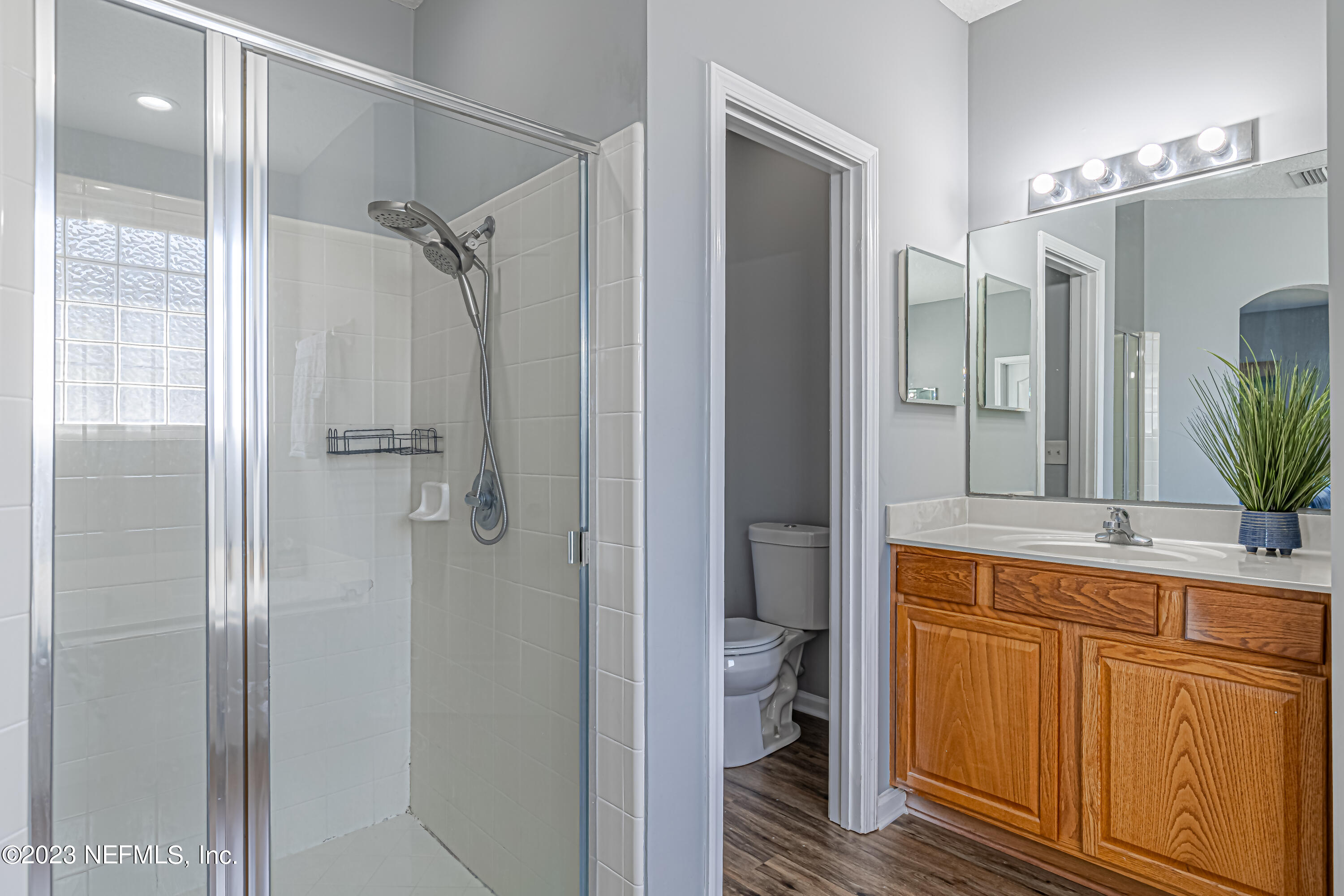 3795 Bedford Drive Middleburg, FL 32068 - Photo 32 of 54 a bathroom with a granite countertop sink mirror and shower