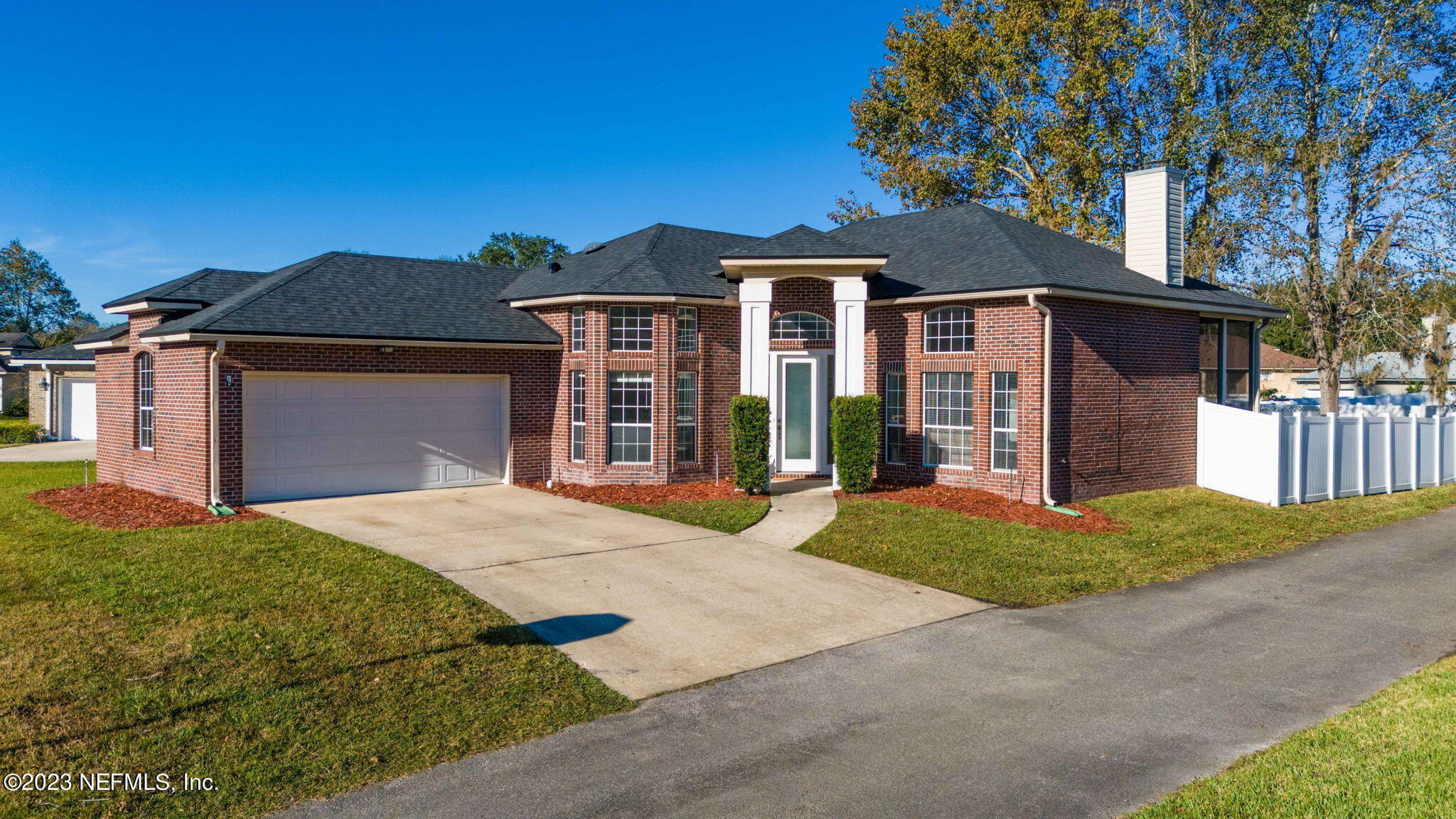 3795 Bedford Drive Middleburg, FL 32068 - Photo 41 of 54 a front view of a house with a yard and garage