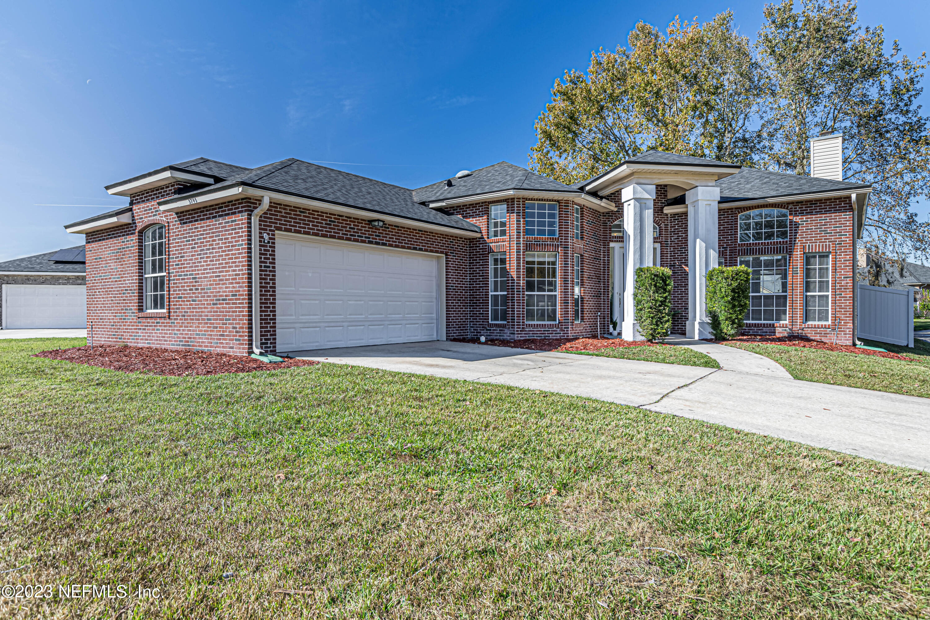 3795 Bedford Drive Middleburg, FL 32068 - Photo 52 of 54 a front view of a house with a garden