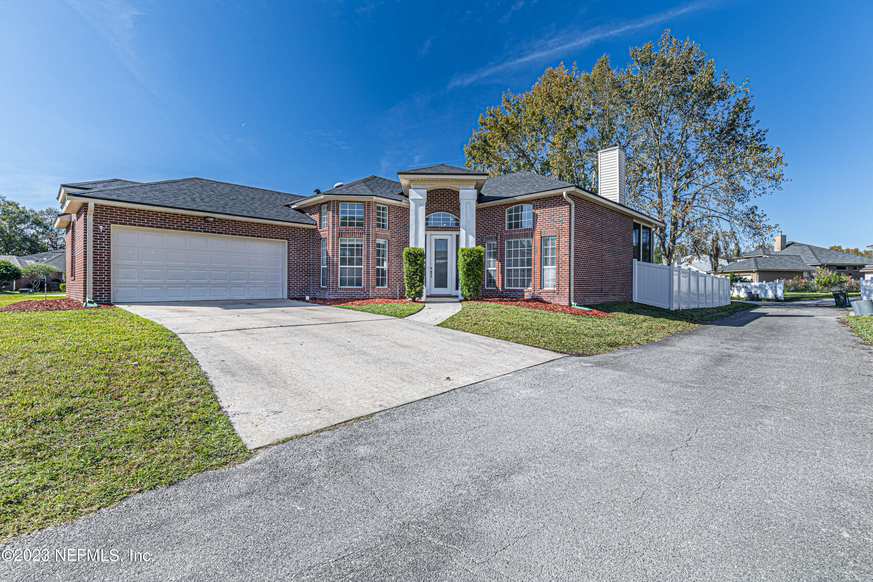 3795 Bedford Drive Middleburg, FL 32068 - Photo 53 of 54 a front view of a house with a yard and garage