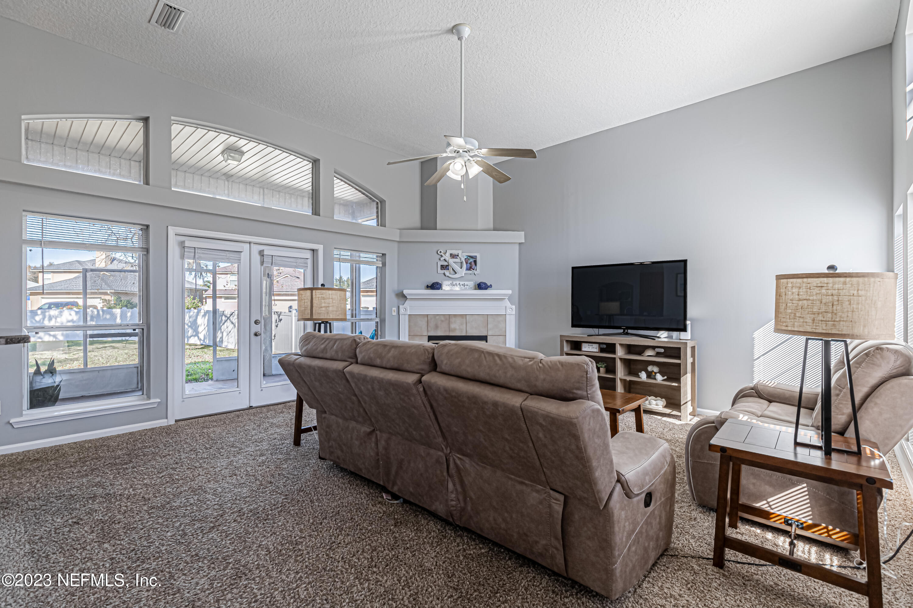 3795 Bedford Drive Middleburg, FL 32068 - Photo 7 of 54 a living room with furniture a flat screen tv and a fireplace