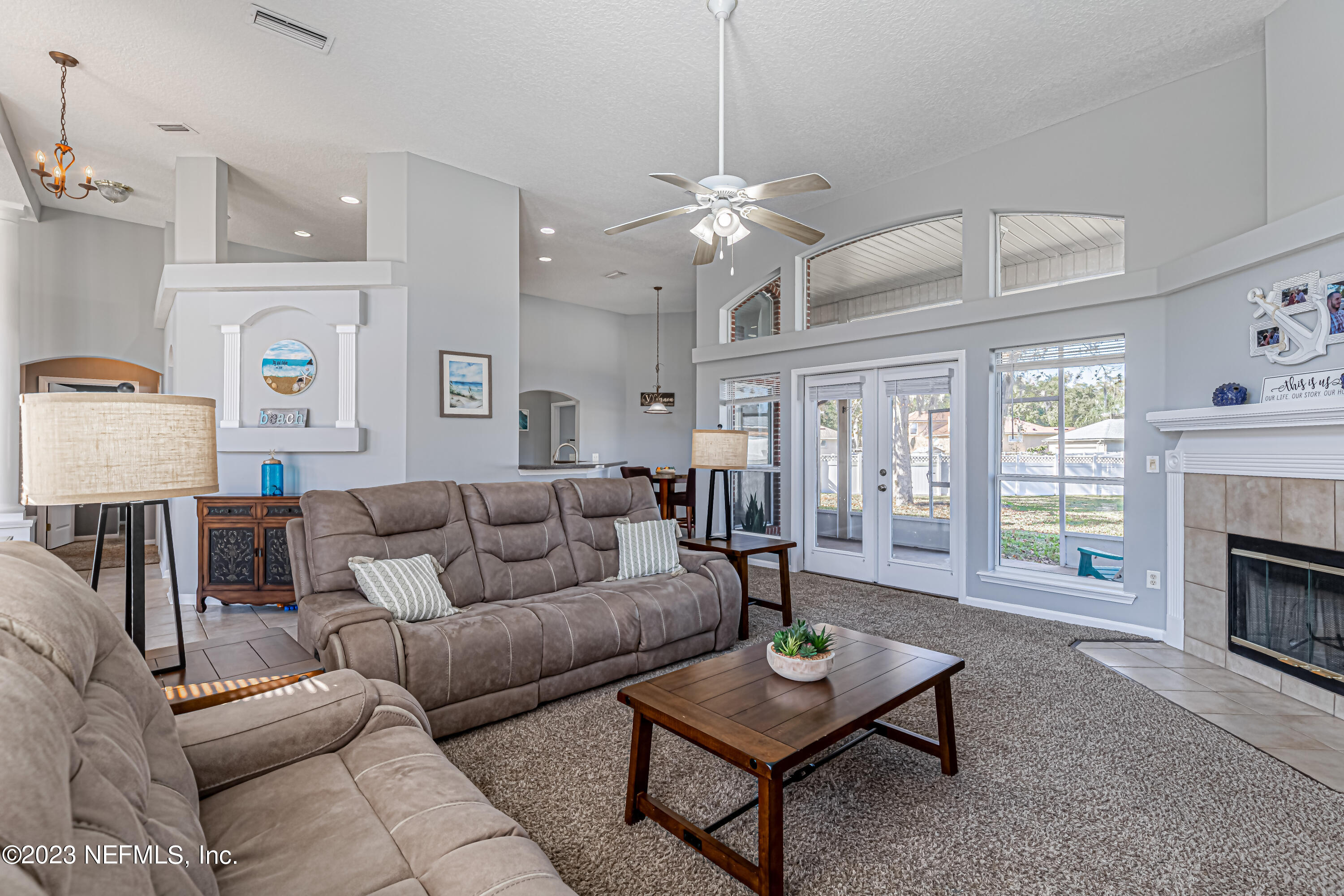 3795 Bedford Drive Middleburg, FL 32068 - Photo 8 of 54 a living room with furniture a fireplace and a table