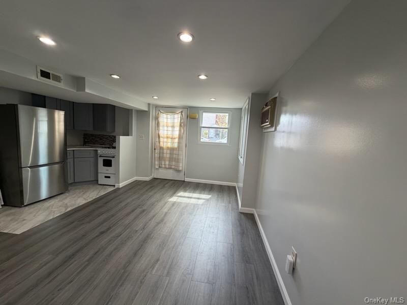 a view of a kitchen with a sink and a refrigerator