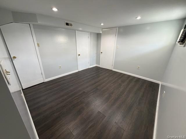 179-11 Eveleth Road Queens, NY 11434 - Photo 4 of 6 an empty room with wooden floor and windows