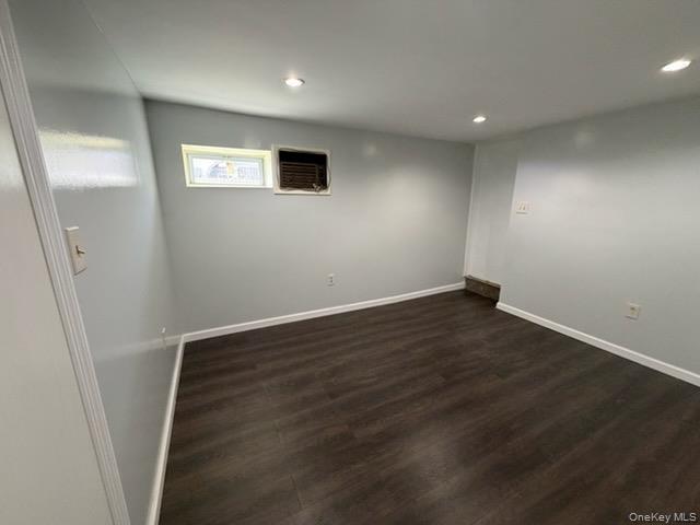 179-11 Eveleth Road Queens, NY 11434 - Photo 5 of 6 an empty room with wooden floor and windows