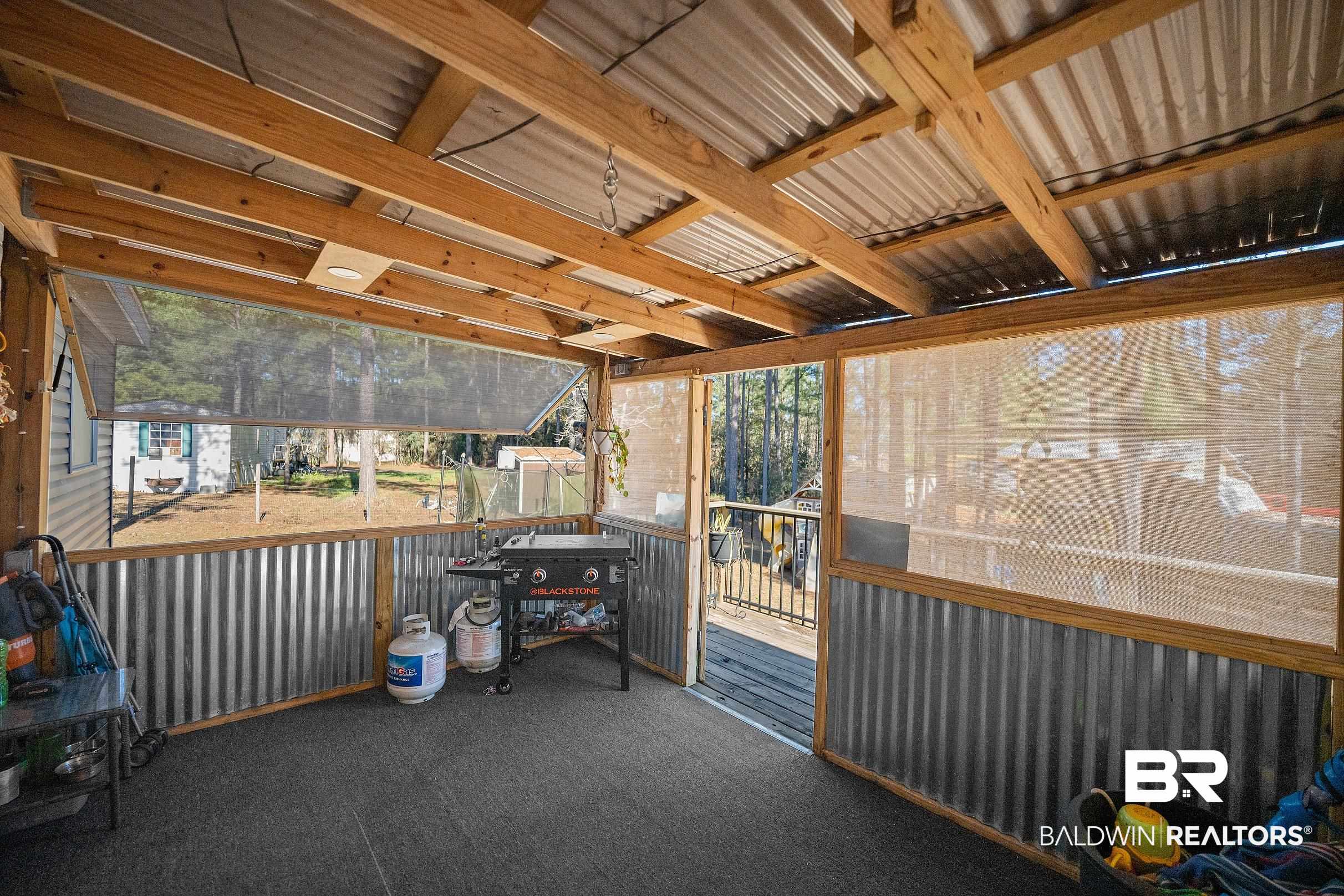 8630 Allison Lane Wilmer, AL 36587 - Photo 25 of 31 View of patio / terrace featuring a sunroom