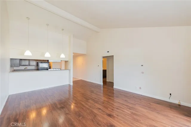 a view of a kitchen with wooden floor