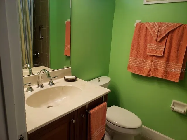a bathroom with a sink vanity and a toilet