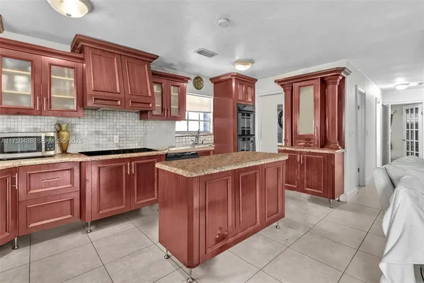 a kitchen that has a sink and a stove