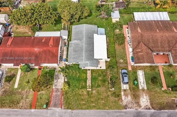 an aerial view of residential houses with outdoor space and street view