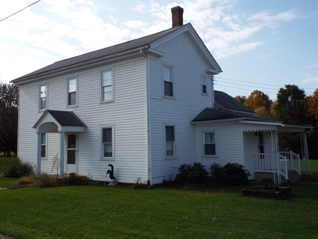 92 Spring Road Parker, PA 16049 - Photo 1 of 1 a front view of a house with a garden