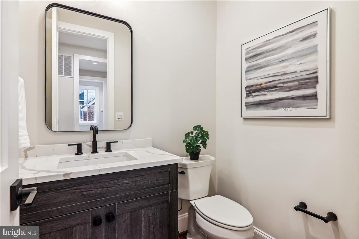 6217 Plainview Road Bethesda, MD 20817 - Photo 10 of 13 a bathroom with a toilet a sink and mirror