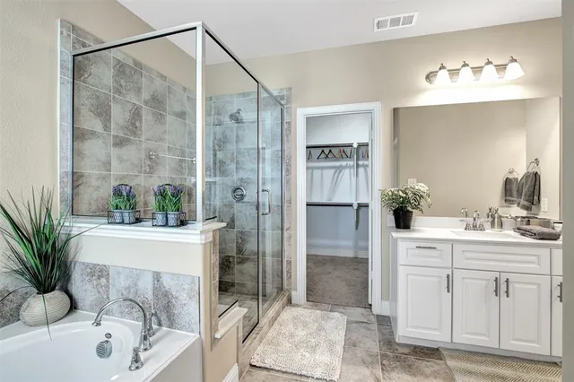 a bathroom with a sink a tub and a mirror