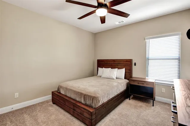 a bed sitting in a bedroom next to a window