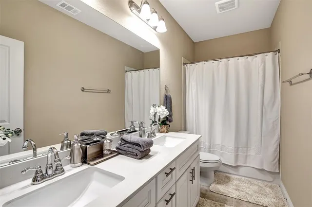 a bathroom with a sink double vanity and a mirror