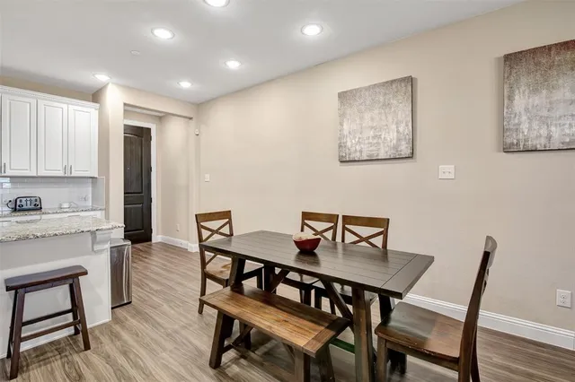 a view of a dining room with furniture and wooden floor