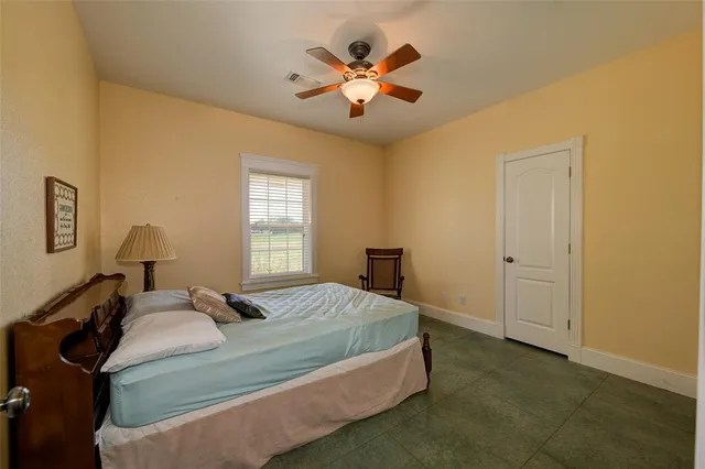 a bedroom with a bed and window