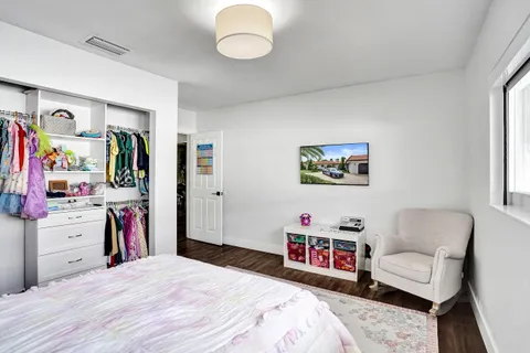 a bedroom with a bed and a couch