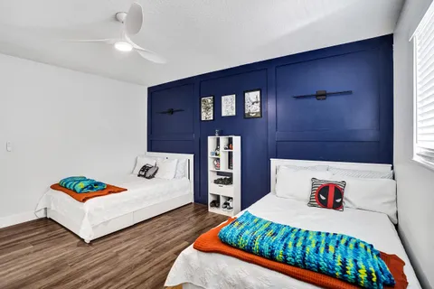 a bedroom with furniture and a wooden floor