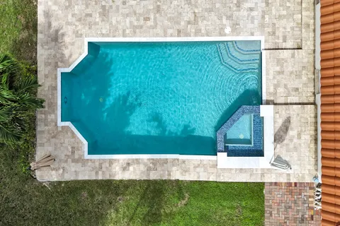 a view of a patio with a table and chairs under an umbrella