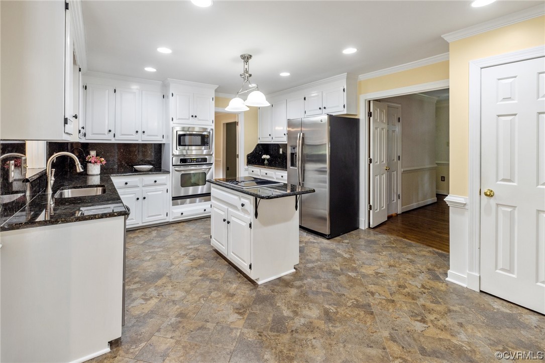 2210 Albion Road Midlothian, VA 23113 - Photo 17 of 36 a kitchen with granite countertop a refrigerator and a stove top oven