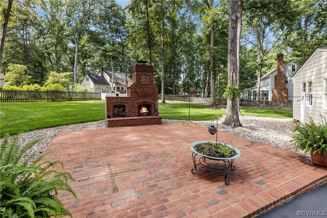 2210 Albion Road Midlothian, VA 23113 - Photo 33 of 36 a view of a backyard with table and chairs potted plants and a large tree