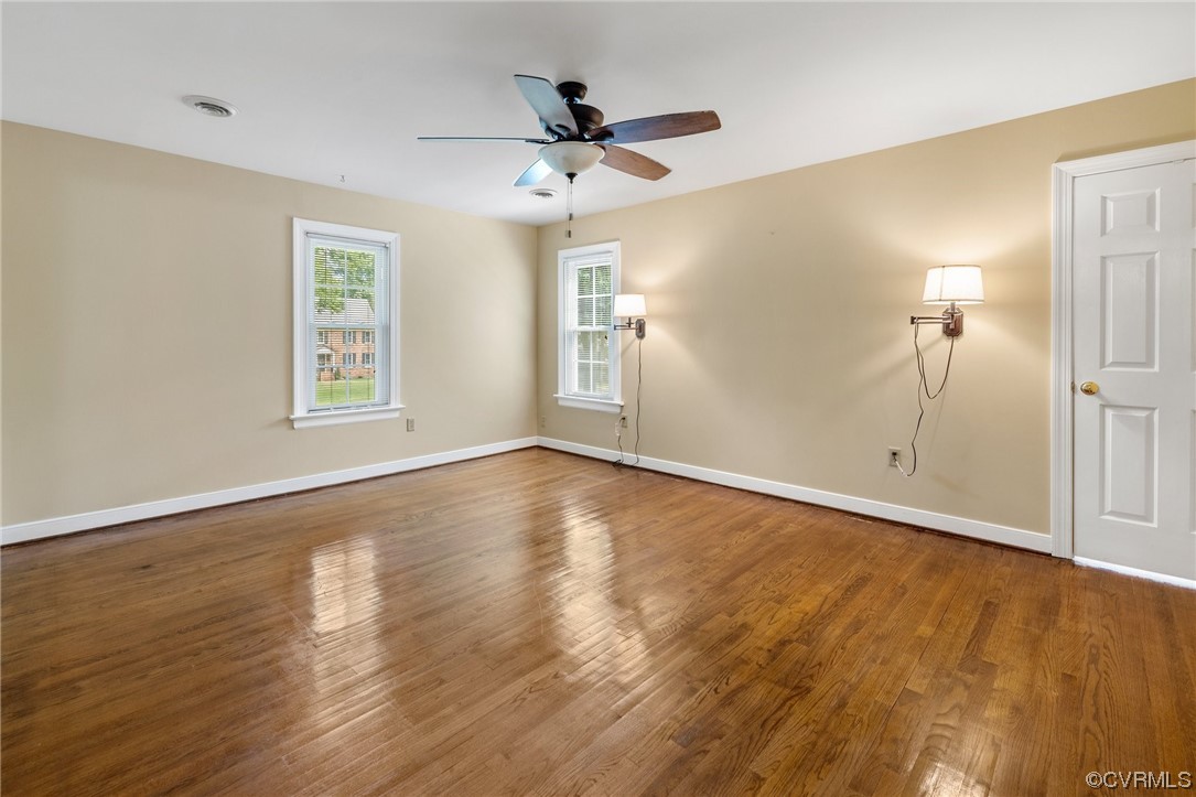 2210 Albion Road Midlothian, VA 23113 - Photo 7 of 36 a view of a livingroom with wooden floor and a ceiling fan