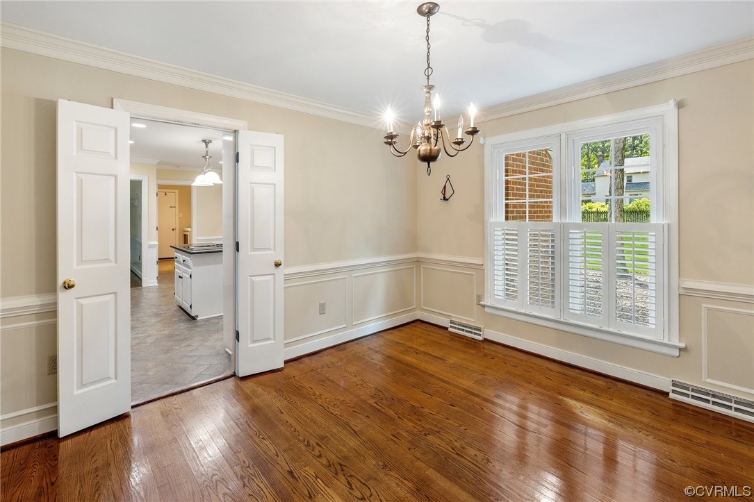 2210 Albion Road Midlothian, VA 23113 - Photo 9 of 36 an empty room with wooden floor a chandelier and windows