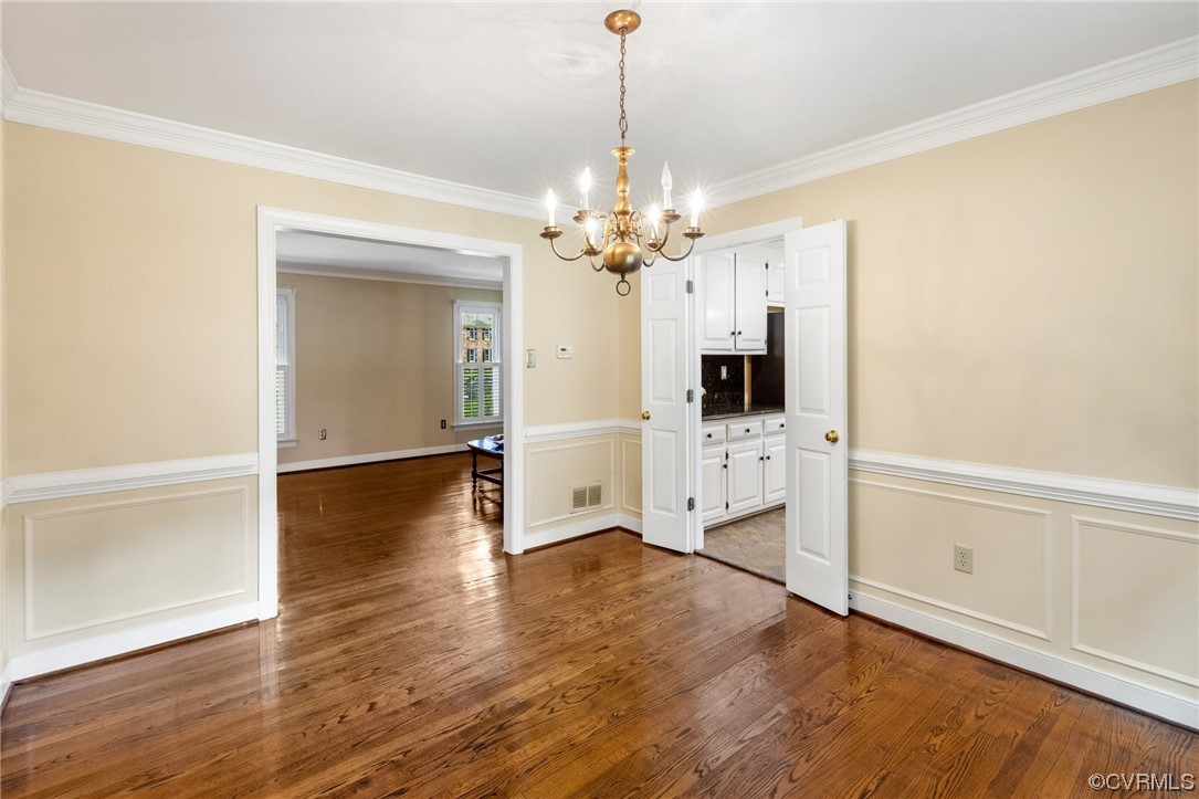2210 Albion Road Midlothian, VA 23113 - Photo 10 of 36 a view of a livingroom with wooden floor and a kitchen space