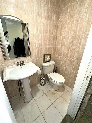 a bathroom with a sink mirror and toilet