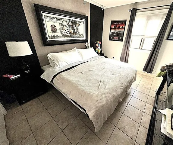 a bed sitting in a bedroom next to a window