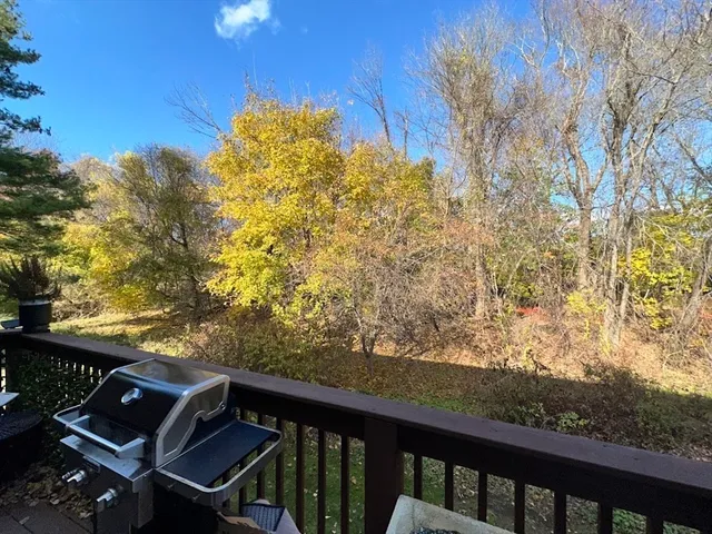 a view of a balcony with chair and wooden fence