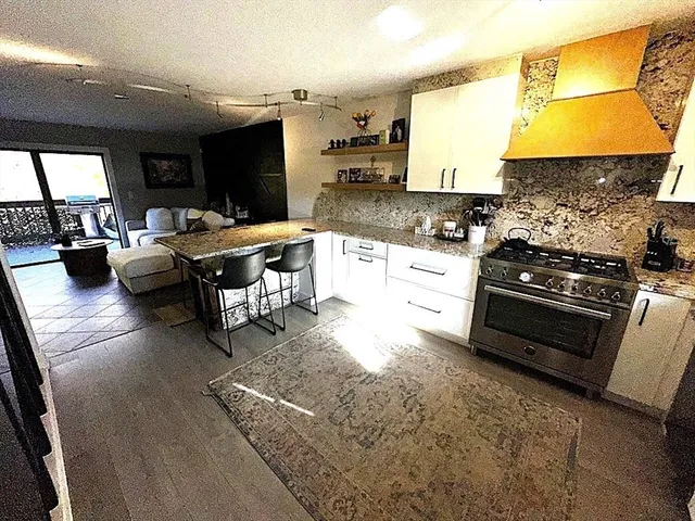 a kitchen with stainless steel appliances granite countertop a stove a sink dishwasher and cabinets