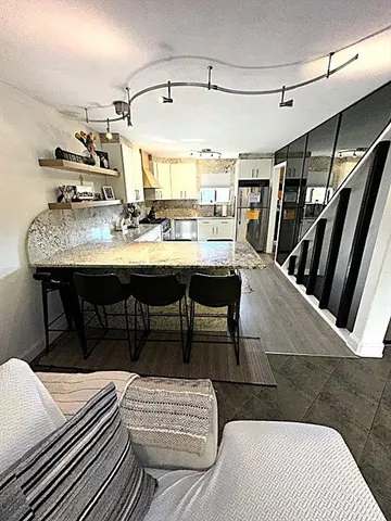 a living room with a couch and a chandelier