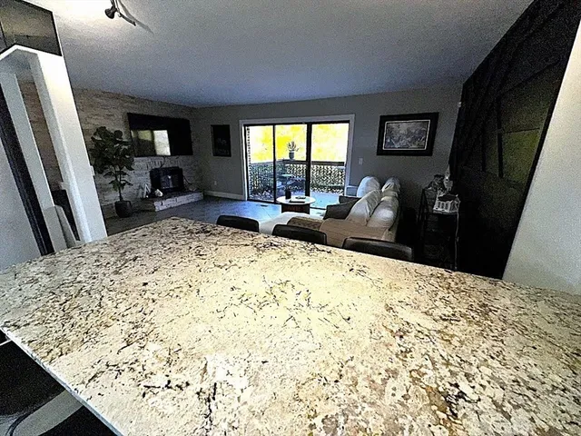 a living room with a couch and a dresser next to a window