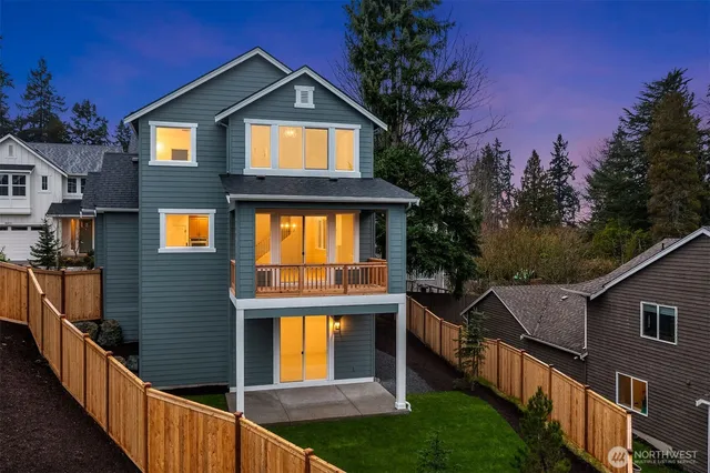 a front view of a house with yard and green space
