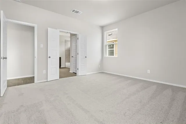 a view of an empty room and closet area
