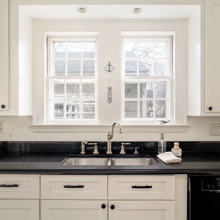 162 Colon Street Beverly, MA 01915 - Photo 17 of 35 a sink a window and white cabinets