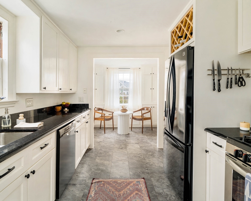 162 Colon Street Beverly, MA 01915 - Photo 18 of 35 a kitchen with stainless steel appliances granite countertop a refrigerator and a stove top oven