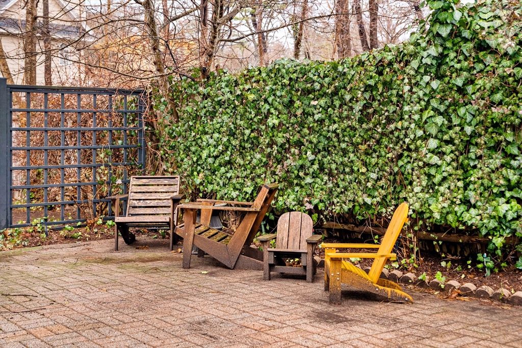 162 Colon Street Beverly, MA 01915 - Photo 32 of 35 a view of a chairs and bench sitting in backyard of house