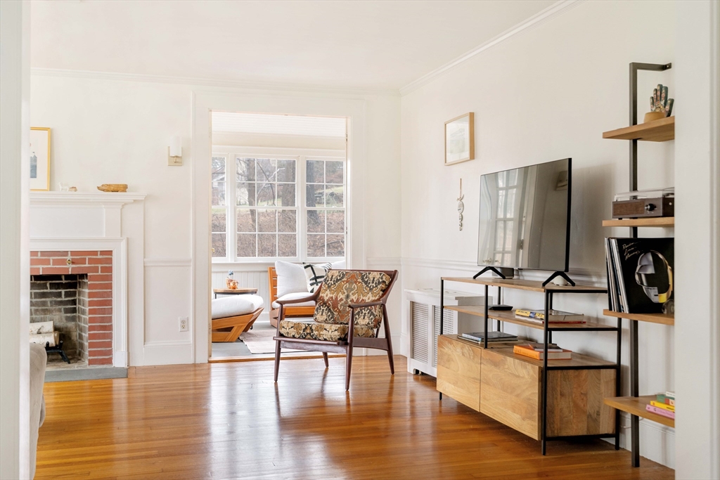 162 Colon Street Beverly, MA 01915 - Photo 5 of 35 a living room with fireplace furniture and a wooden floor