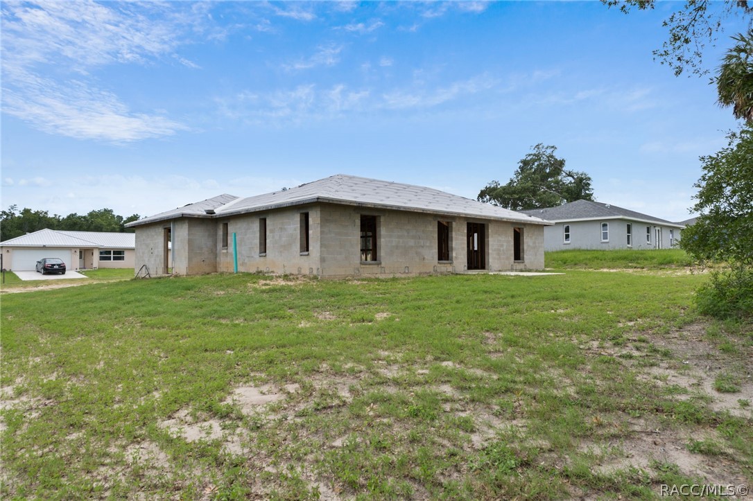 4525 East Rejoice Street Inverness, FL 34453 - Photo 32 of 32 a front view of a house with a garden